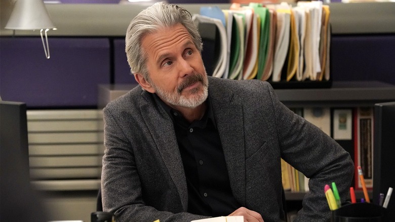 Agent Parker leaning over at his desk in NCIS