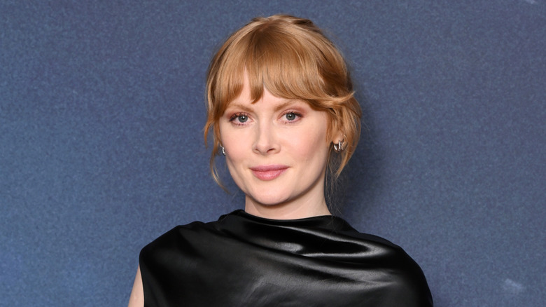 Emily Beecham wearing a black dress