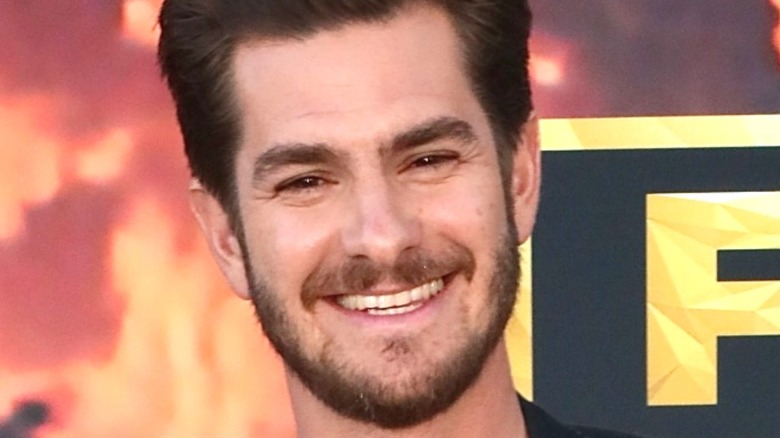 Andrew Garfield grinning at a press event