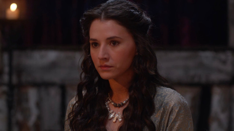 Queen Iseult wears a silver dress