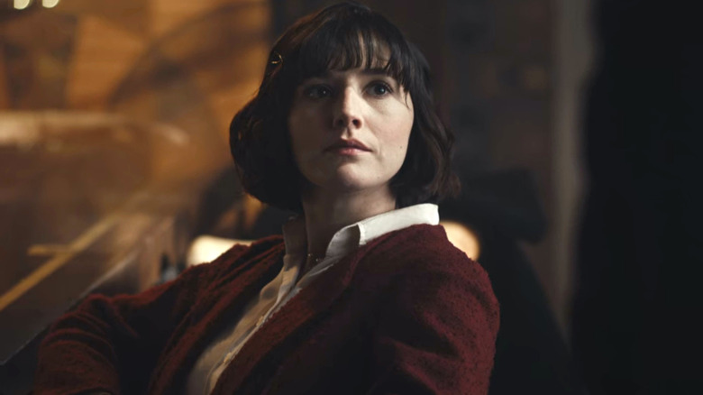Jessie Eden wears a red sweater