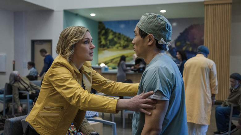 Pluribus Carol grabbing Dr. Nguyen's arms in hospital cafe