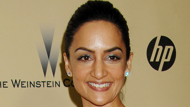 Archie Panjabi smiling red carpet earrings