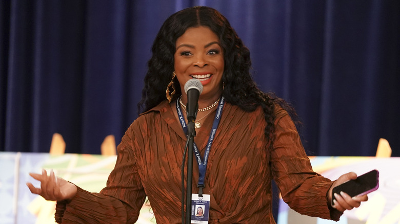 Ava speaking mic holding phone