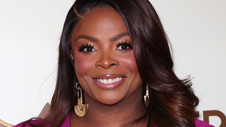 Janelle James at event smiling