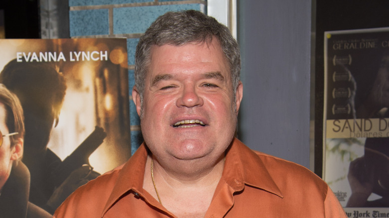 Michael Badalucco smiles