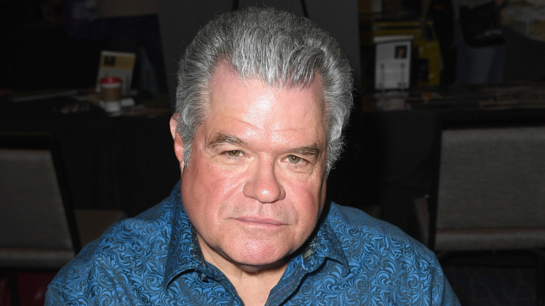 Michael Badalucco poses