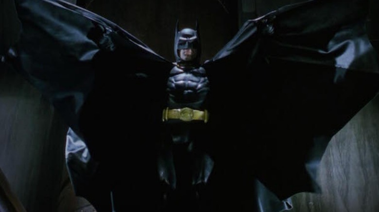 Batman holding his cape