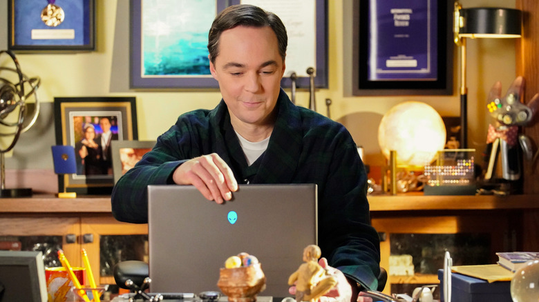 Sheldon smirking at his laptop