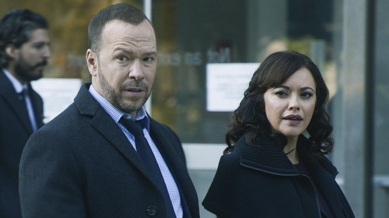 Maria Beaz wearing black jacket next Danny Reagan wearing navy coat