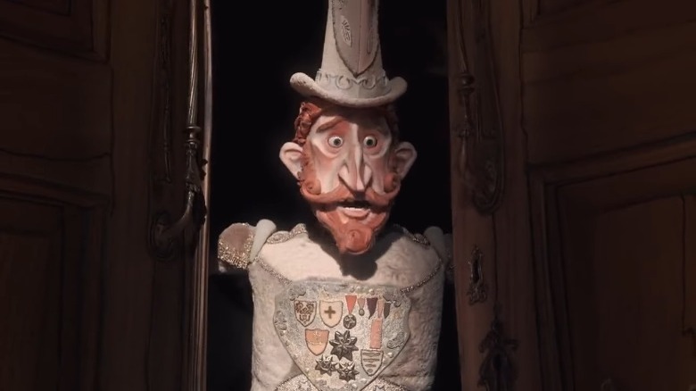Lord Portley-Rind holds the palace doors open