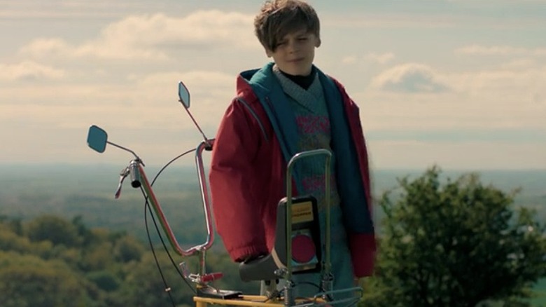 Billy Barratt with bike in red coat