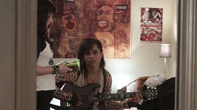Becca standing next to Pearl and her guitar