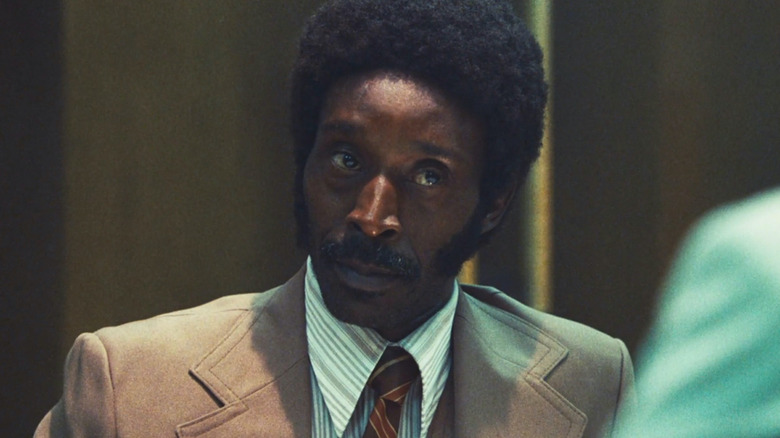 Rob Morgan wears a suit