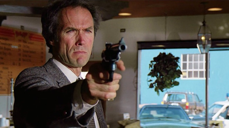 Harry aims his pistol at a criminal in
