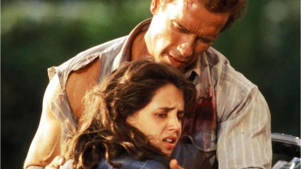 Arnold Schwarzenegger holding Eliza Dushku