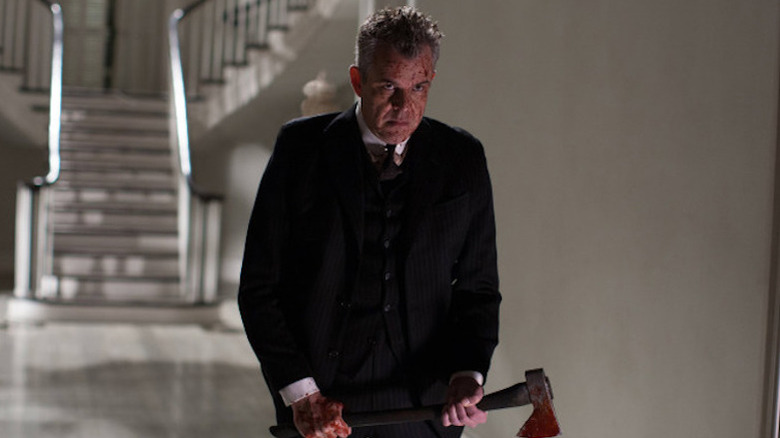 Danny Huston wielding a hatchet in American Horror Story