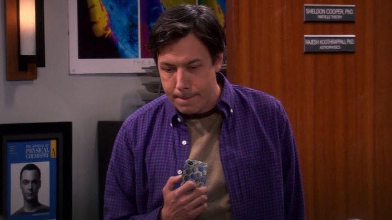 Barry Kripke holding a phone
