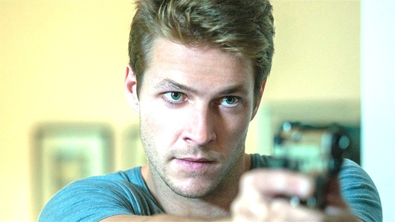 Luke Bracey pointing gun