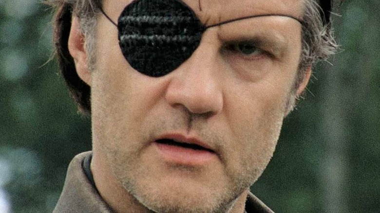 Governor with eyepatch glaring