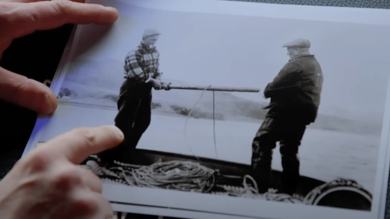 Jake Anderson looks at an old photograph in Deadliest Catch