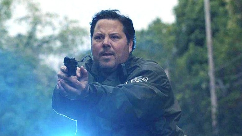 Boucher pointing a gun