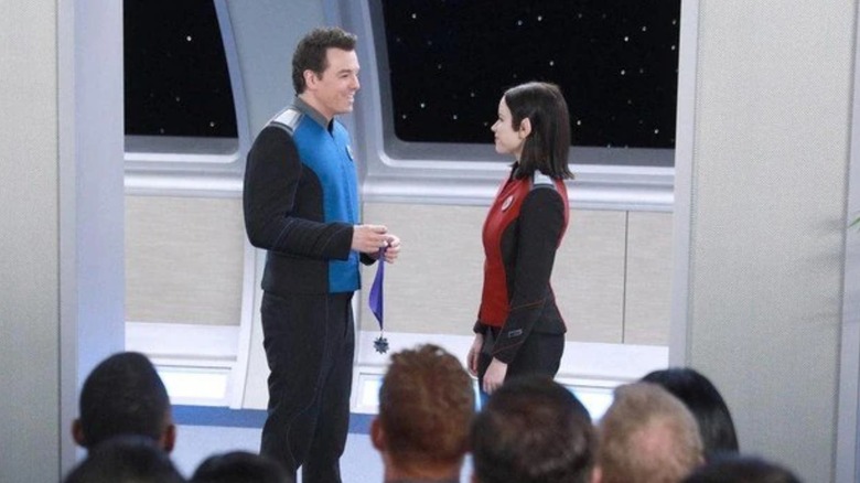 Captain Ed Mercer of the Orville awards Alara a medal