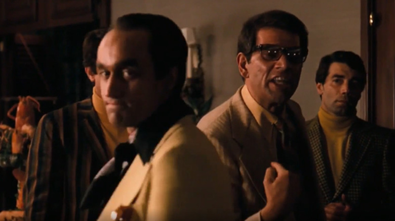 Fredo looking on as Moe Greene yells