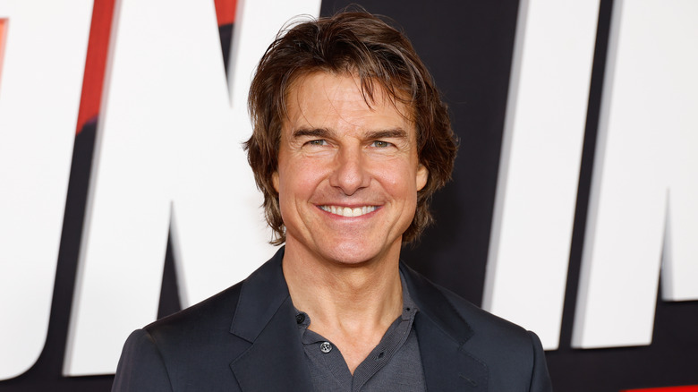 Tom Cruise smiles widely
