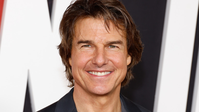 Tom Cruise smiles widely
