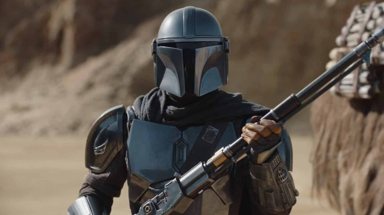 Mandalorian holding rifle