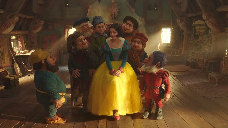Snow White surrounded by the dwarfs in Snow White (2025)