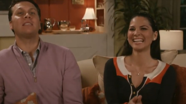 Olivia Munn laughs with her character's husband in Perfect Couples