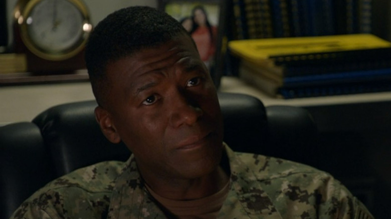 Commander Daly frowning 