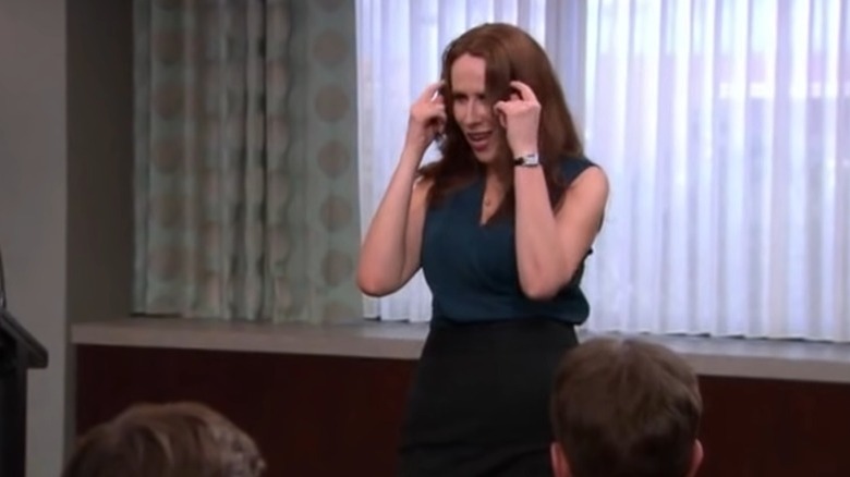 Nellie Bertram pointing at her own head