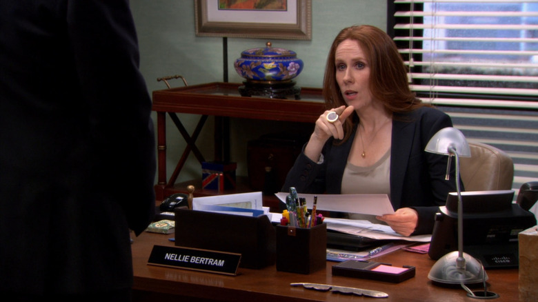 Nellie Bertram pointing to door