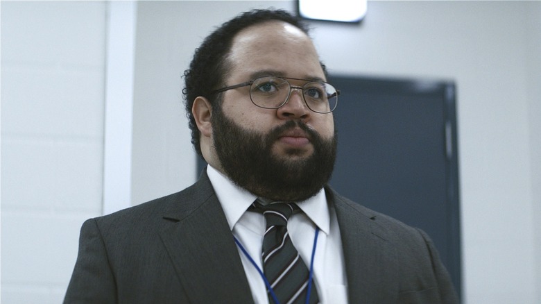 Dylan looking to the side in Severance Season 1