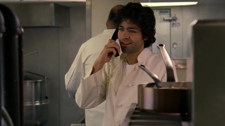 Nate Cooper on the phone in a kitchen in The Devil Wears Prada