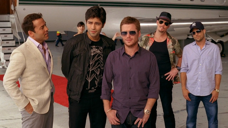 Ari, Vince, Eric, Drama, and Turtle in front of a private jet on Entourage