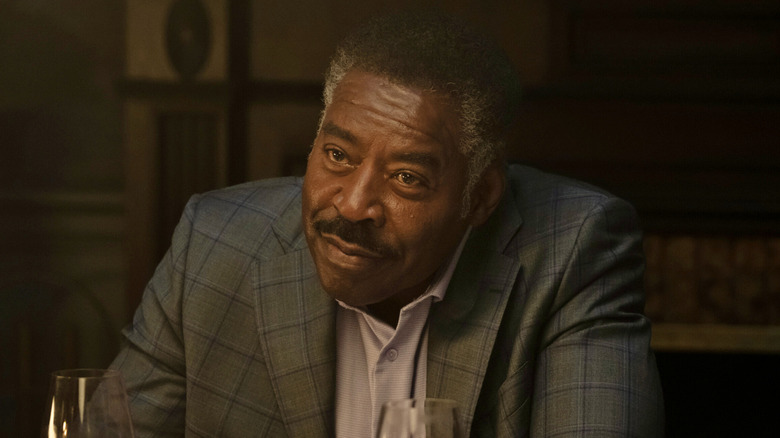 Reverend Edwin Peters smiles at the dinner table in 