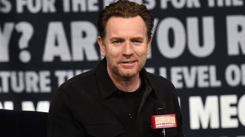 Ewan McGregor half smiles