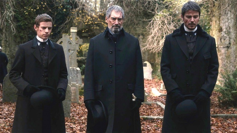 Frankenstein, Murray, and Ethan standing in a cemetery