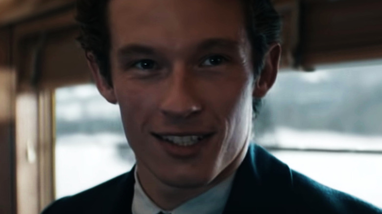 Callum Turner smirking 