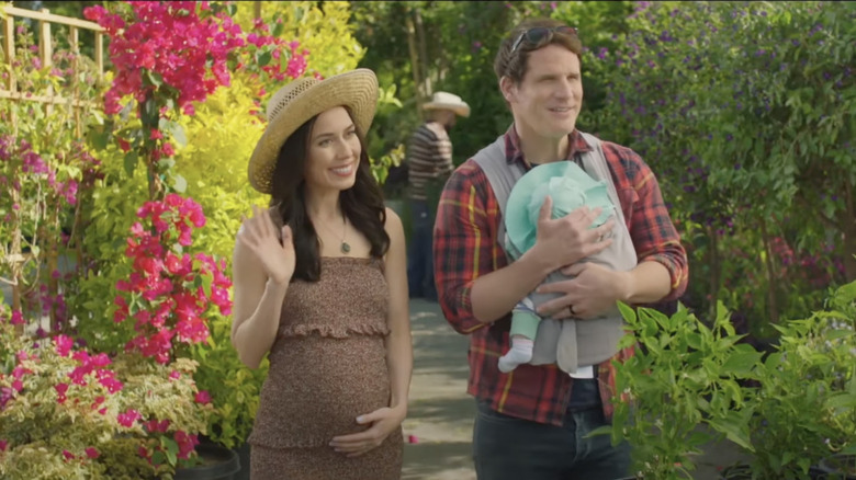 Gia and husband holding child