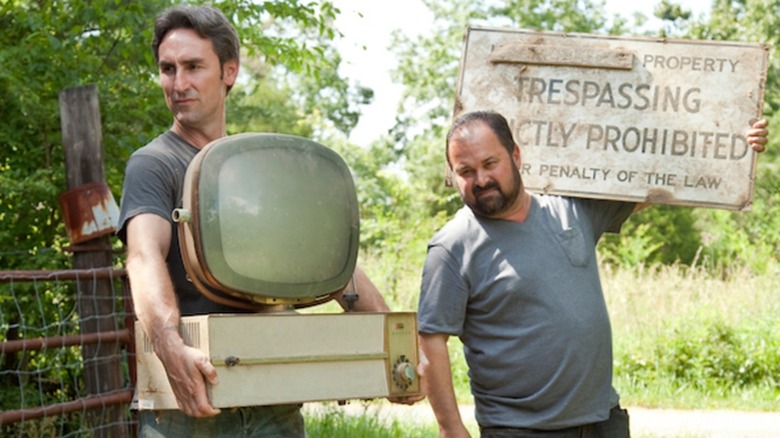Mike Wolfe and Frank Fritz holding antiques