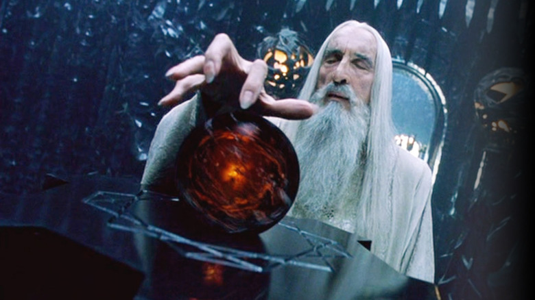 Saruman holds his hand over a palantir in The Fellowship of the Ring