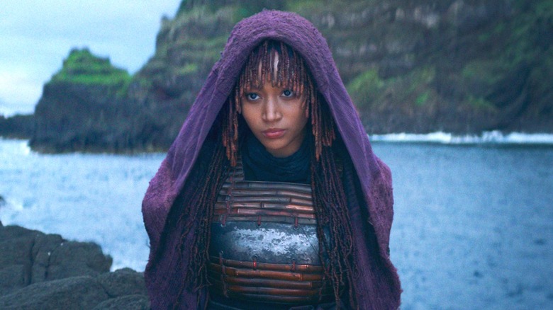 Mae standing on island