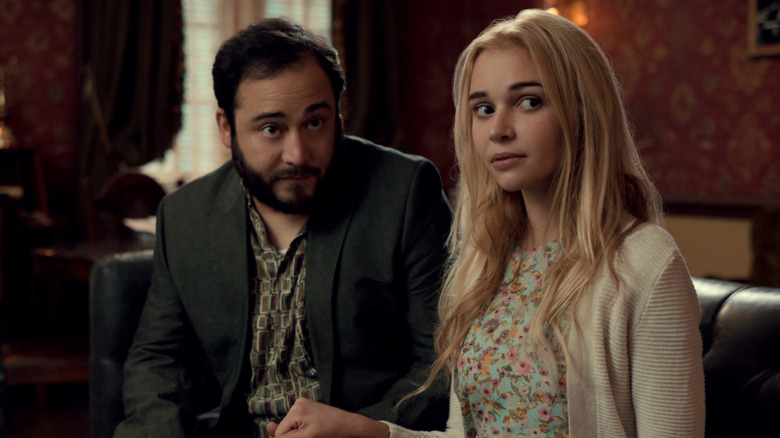 Anthony and Georgia sit on a leather couch in "Ginny and Georgia" (2021-present)