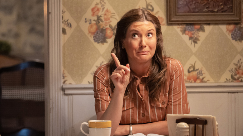 Mary Cooper pointing a finger at the dining room table on Georgie & Mandy's First Marriage