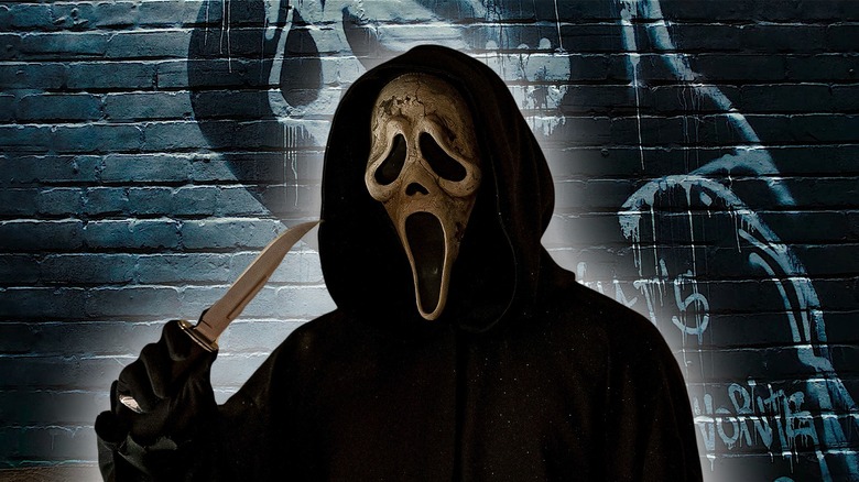 Ghostface holding knife by graffiti 